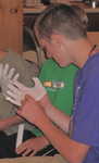 Students are introduced to use of gloves when handling artifacts